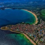 Aerial view of Primorsko, Bulgaria, venue of the Erasmus+ Partnership Building Activity — the town on a peninsula between two Black Sea beaches